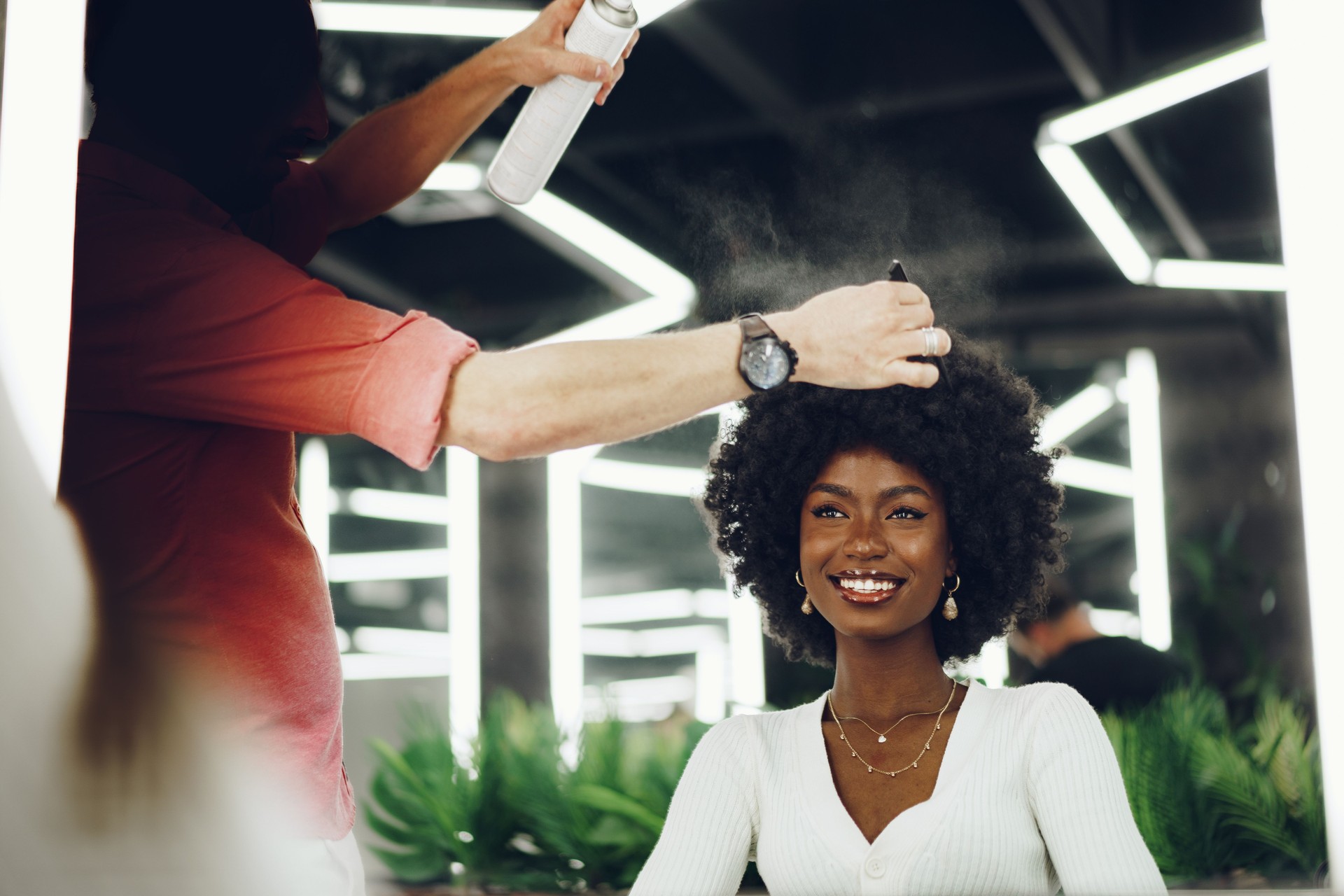 Young african woman customer getting a hairstyle at a beauty salon.