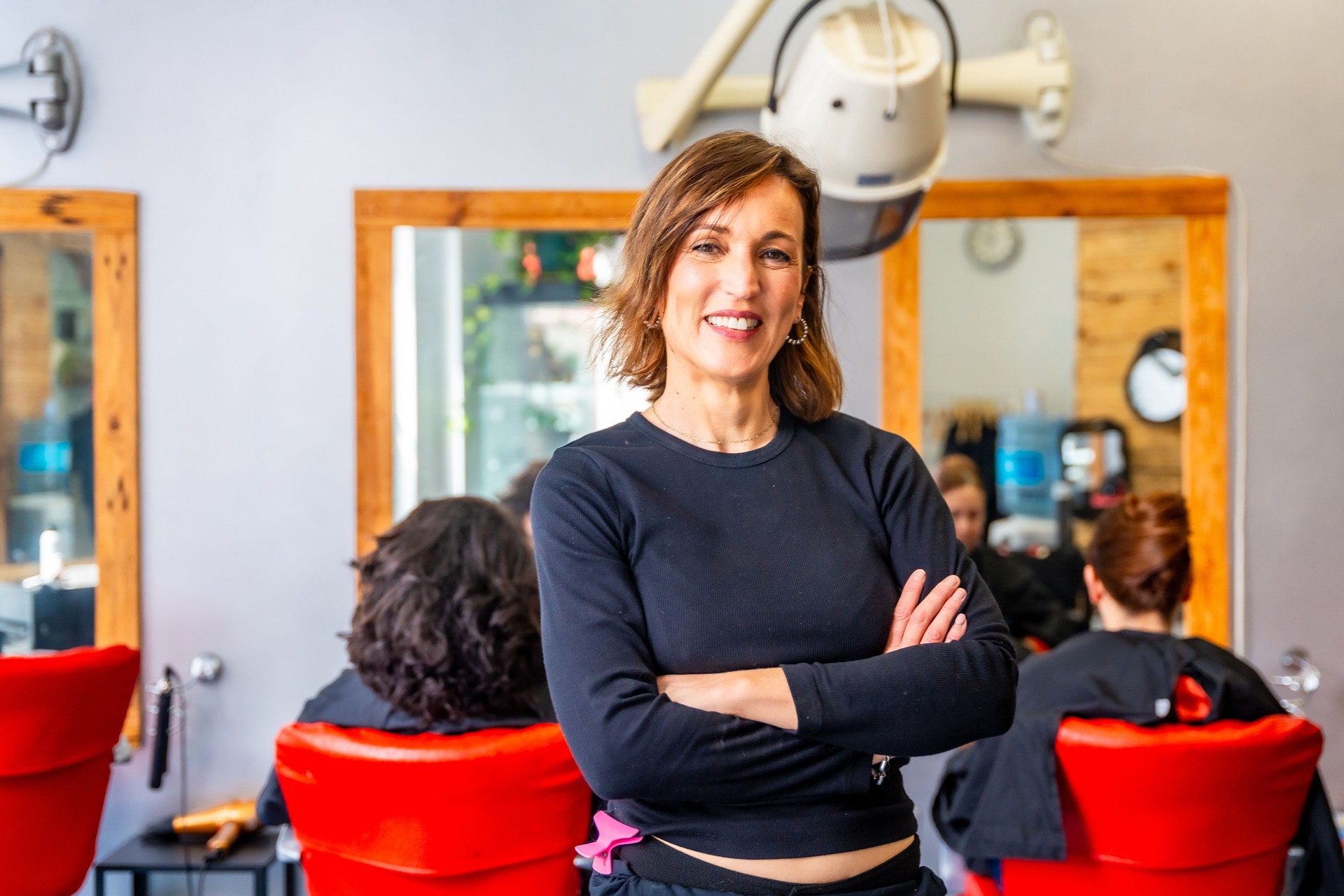 Portrait of a happy and proud hairdresser in the salon