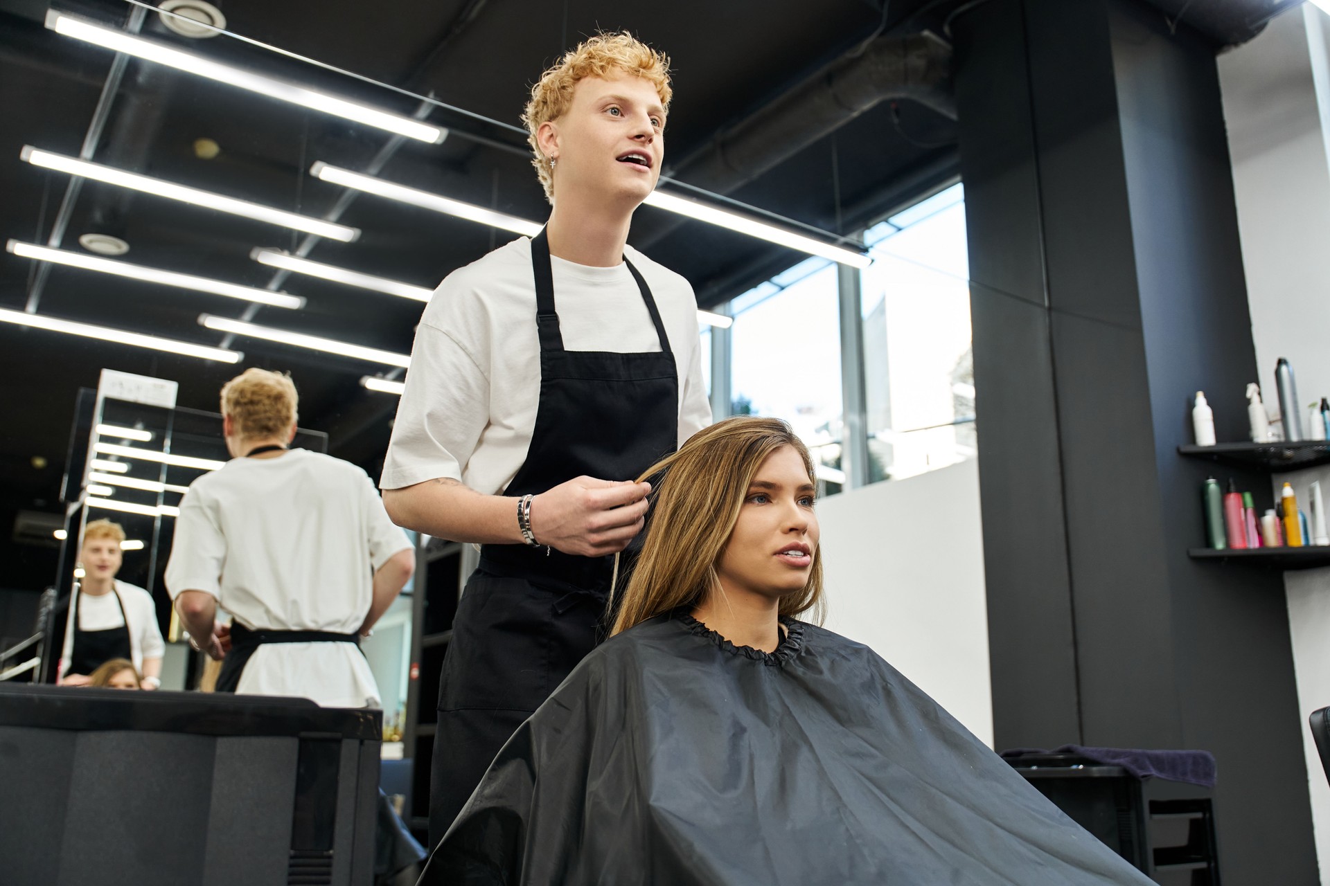 Talented stylist enhances beautiful clients look in a modern beauty salon setting